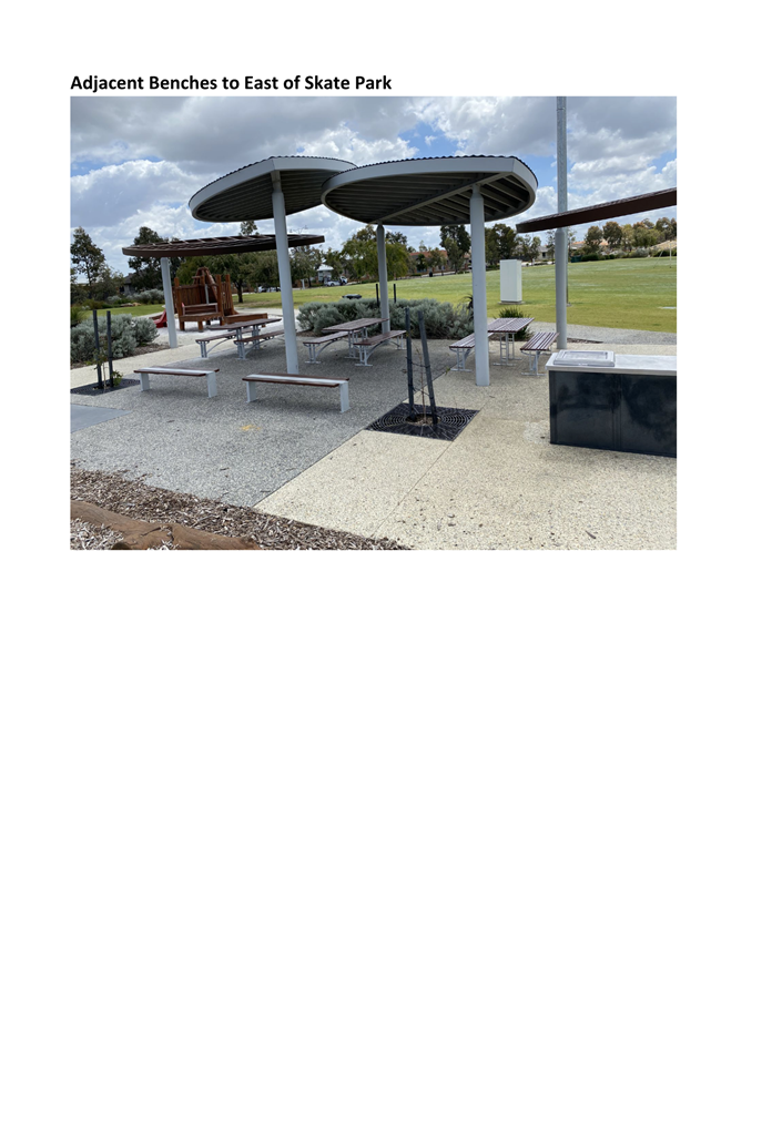 A group of benches and a picnic table

Description automatically generated