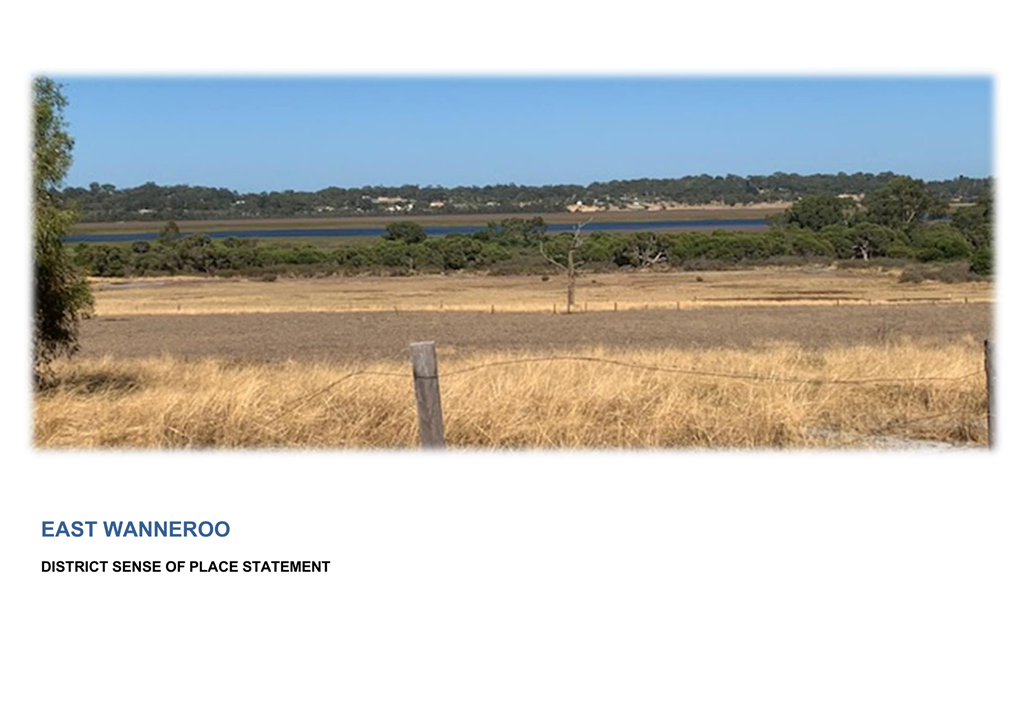 A field with trees and a body of water in the background

Description automatically generated