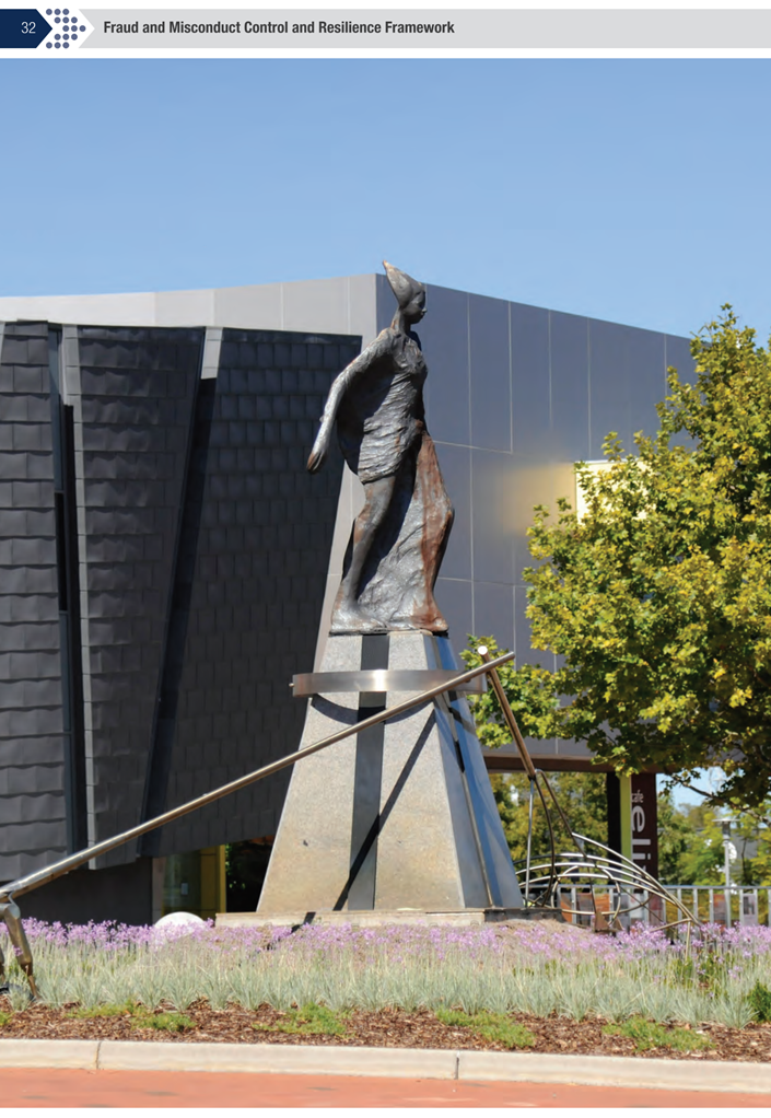 A statue of a person in a field

Description automatically generated