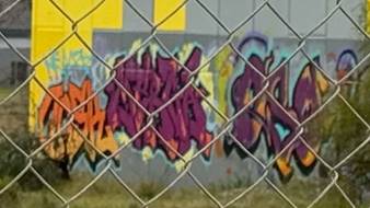 A fence with graffiti on it

AI-generated content may be incorrect.