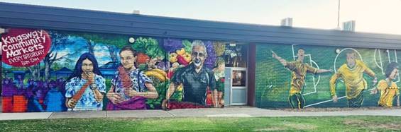 A building with a mural on the side

AI-generated content may be incorrect.