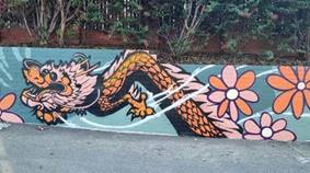 A wall with a dragon and flowers

AI-generated content may be incorrect.