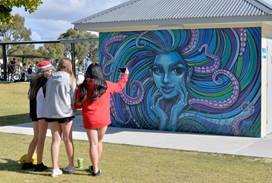 A group of people painting a wall

AI-generated content may be incorrect.