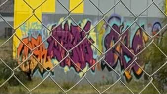 A fence with graffiti on it

AI-generated content may be incorrect.